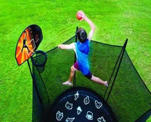 A boy in blue tanktop skies high to dunk his Vuly trampoline basketball and hoop