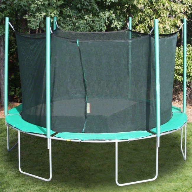 round green trampoline with black net, green poles, next to tree