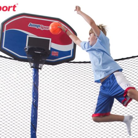 Young boy jumping and dunking his JumpSport ProFlex trampoline basketball hoop