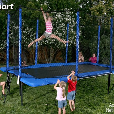 A little girl does gymnastics tricks on her rectangular trampoline