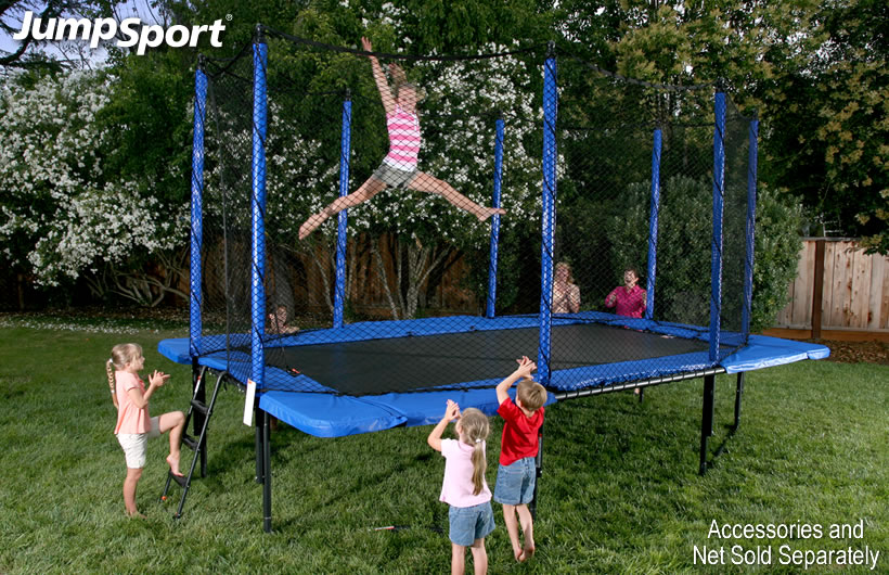 A little girl does gymnastics tricks on her rectangular trampoline