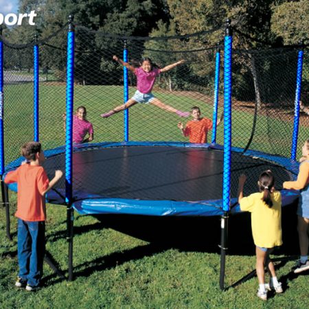 a little girl jumping on a JumpSport SoftBounce trampoline while a group of kids watch and cheer