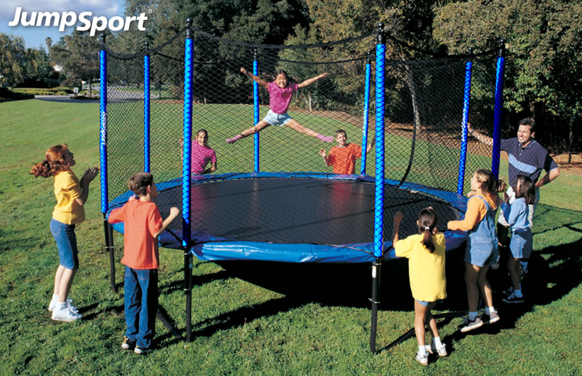 a little girl jumping on a JumpSport SoftBounce trampoline while a group of kids watch and cheer