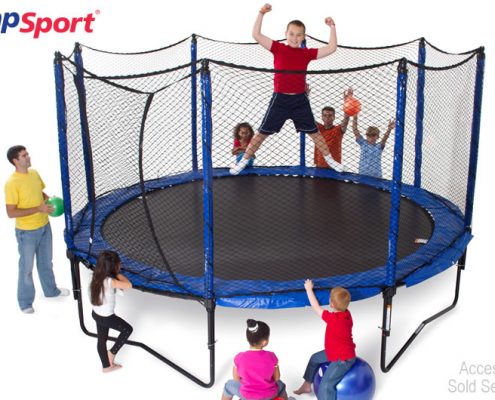 a kid flexing his muscles, while a group of kids watch him jump on a JumpSport trampoline