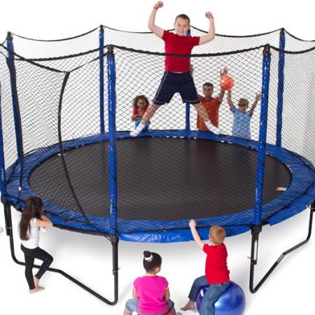 a group of kids standing and cheering around a JumpSport PowerBounce 12 foot trampoline