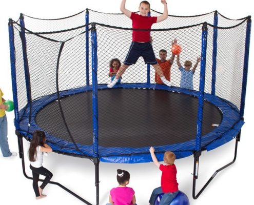 a group of kids standing and cheering around a JumpSport PowerBounce 12 foot trampoline