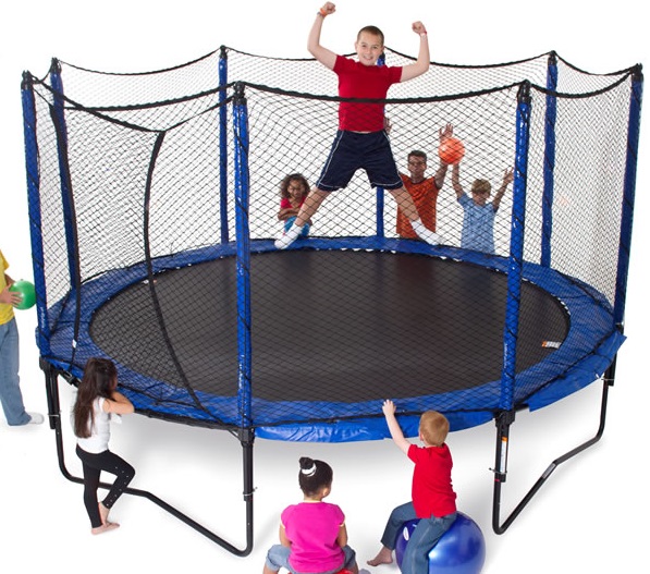 a group of kids standing and cheering around a JumpSport PowerBounce 12 foot trampoline