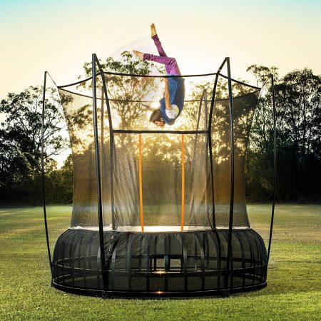 A boy appears to fly upsidedown above a 14 foot extra large Vuly Thunder against a mesmorizing sunset