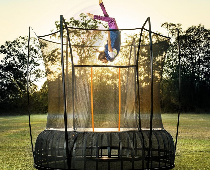 A boy appears to fly upsidedown above a 14 foot extra large Vuly Thunder against a mesmorizing sunset