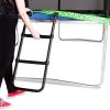 A woman with black yoga pants and red shoes sets a black trampoline ladder against her tramp