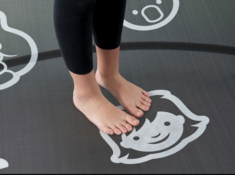 A pair of feet jump on a mat logo