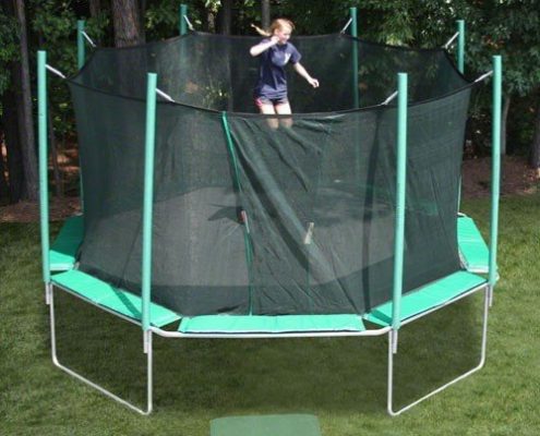 An octagon shaped trampoline with a young girl with ponytails jumping.