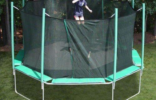 An octagon shaped trampoline with a young girl with ponytails jumping.