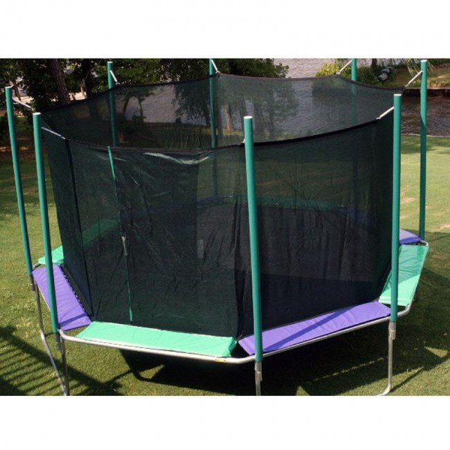 A purple and green Magic Circle trampoline with enclosure on a golf course next to a stream.