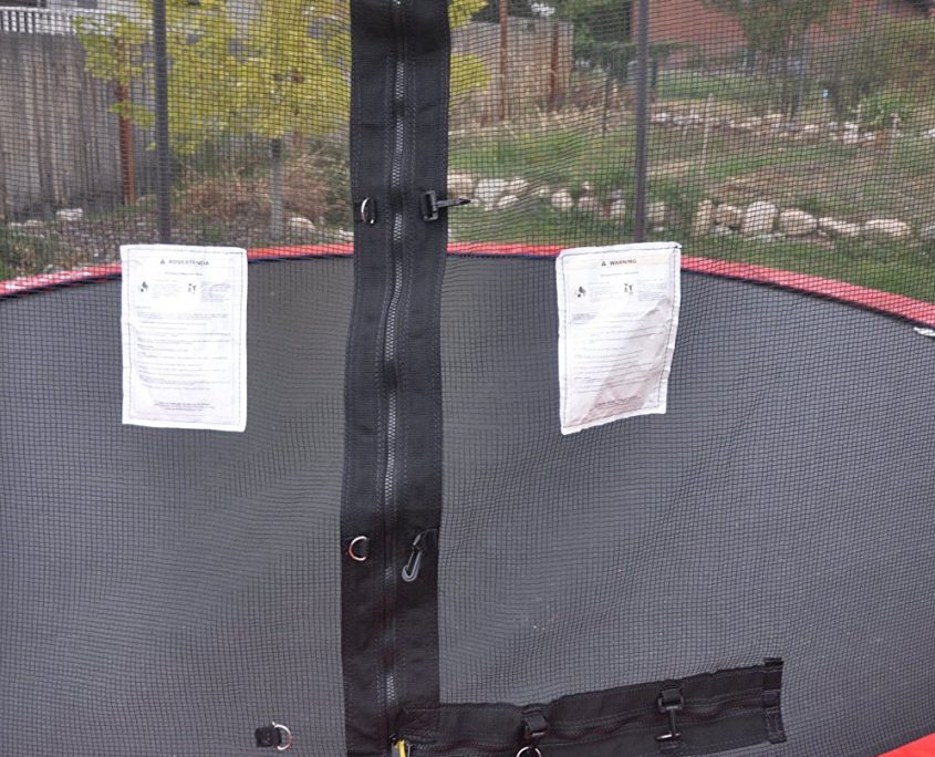 Trampoline safety enclosure door with zipper