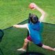 a young boy in blue shirt dunking his Vuly basketball hoop high above his Vuly 2 trampoline